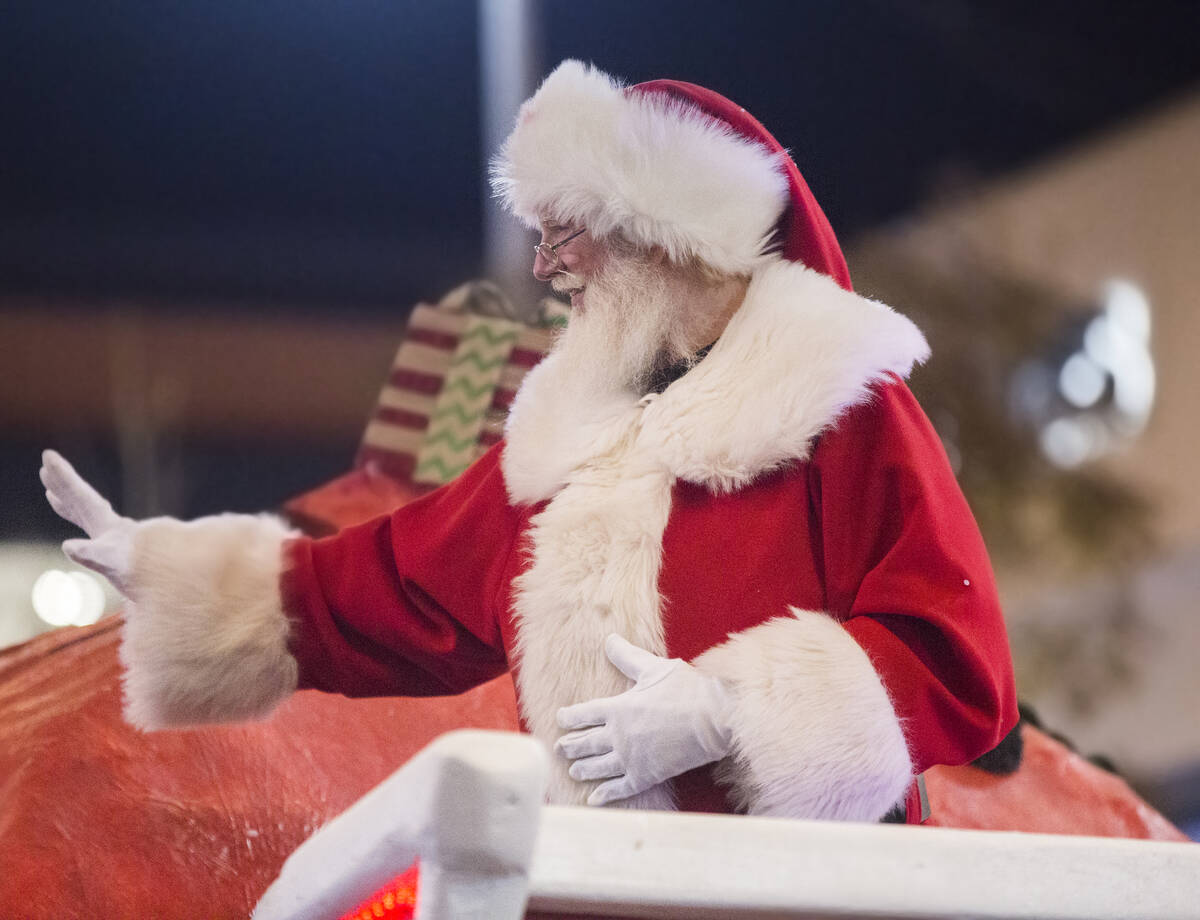Santa waves to the crowd during the Downtown Summerlin Holiday Parade on Festival Plaza Drive o ...