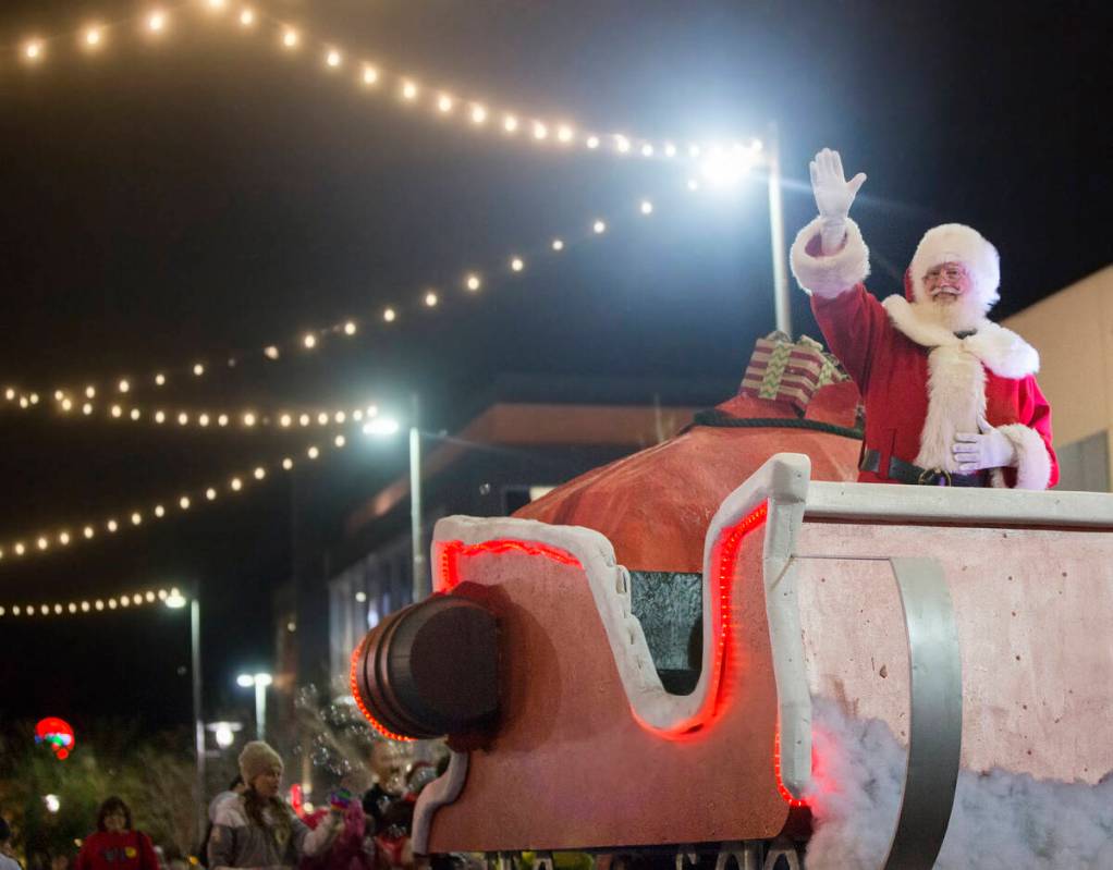 Santa waves to the crowd during the Downtown Summerlin Holiday Parade on Festival Plaza Drive o ...