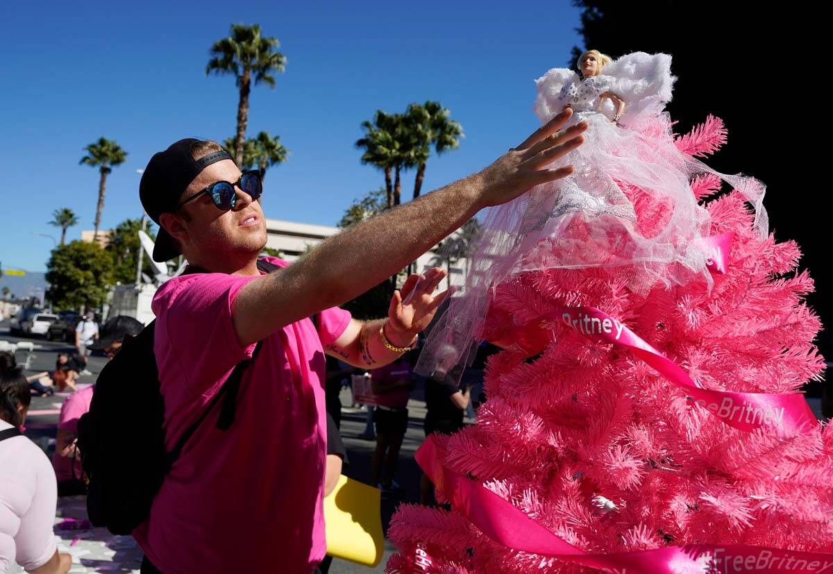 Britney Spears supporter Saige Douglas, of Denver, Col., decorates a "Free Britney" C ...