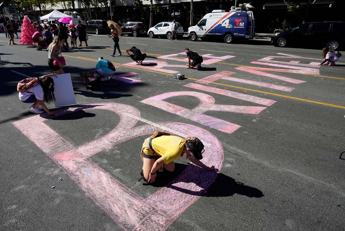 Stacy Moffatt, of Costa Mesa, Calif., bottom, and other Britney Spears supporters color in a &q ...