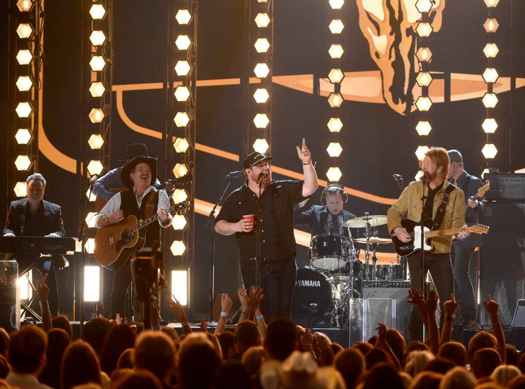 Kix Brooks, left, and Ronnie Dunn, right, of Brooks & Dunn, and Luke Combs perform "Brand New M ...
