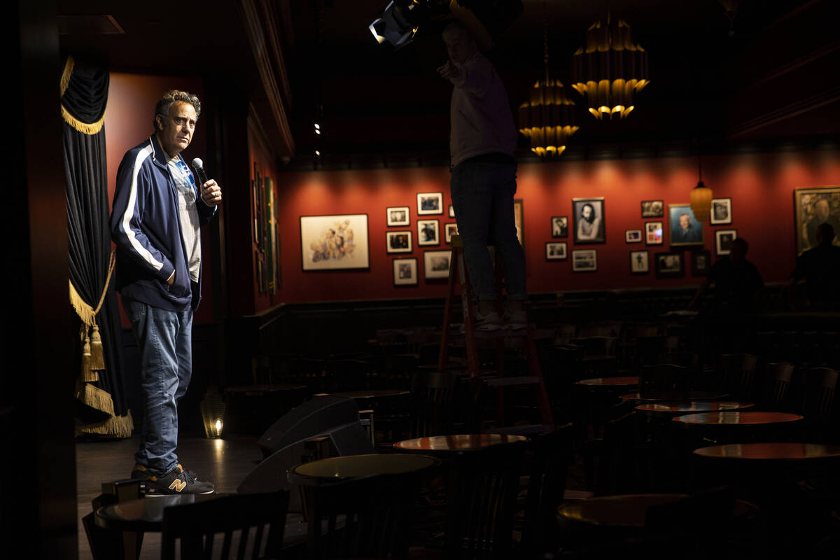 Comedian Brad Garrett stands on stage to test the sound and lights in preparation for his show ...
