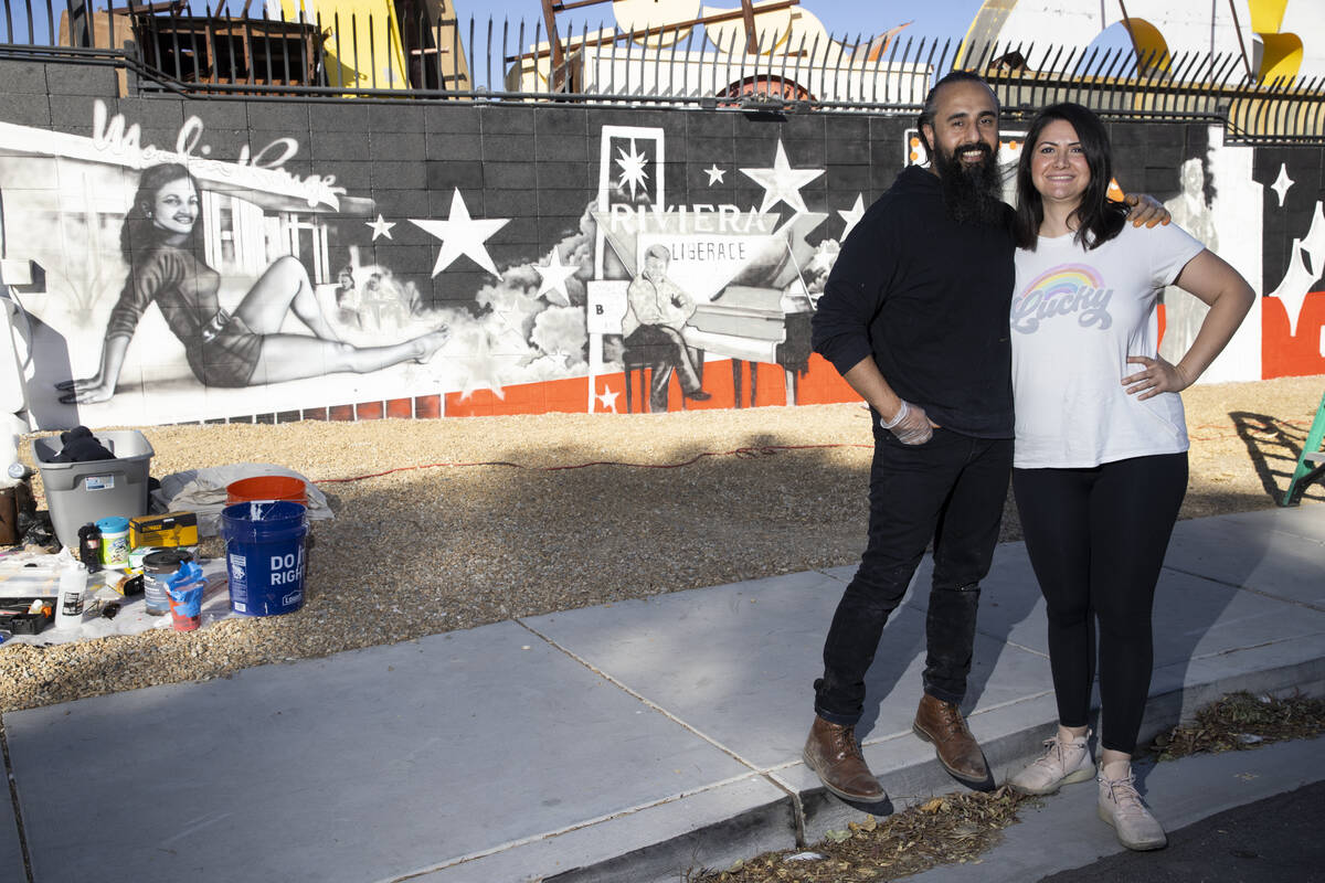 Ali Fathollahi, left, and wife Nanda Sharifpour pose for a portrait in front of a mural they ar ...
