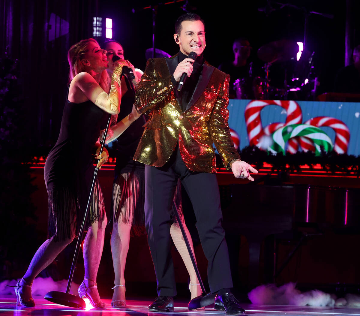 Lou Gazzarra sings "Santa's Back in Town" with Sarah LeClear, left, and Jaclyn McSpad ...