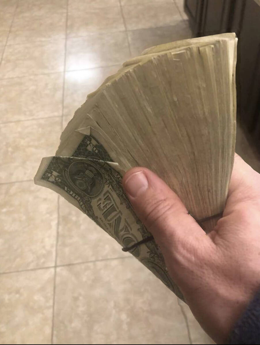 Vegas musician Steve Flora shows Dennis Rodman's $300 tip, all in $100 bills, from Rodman's sto ...