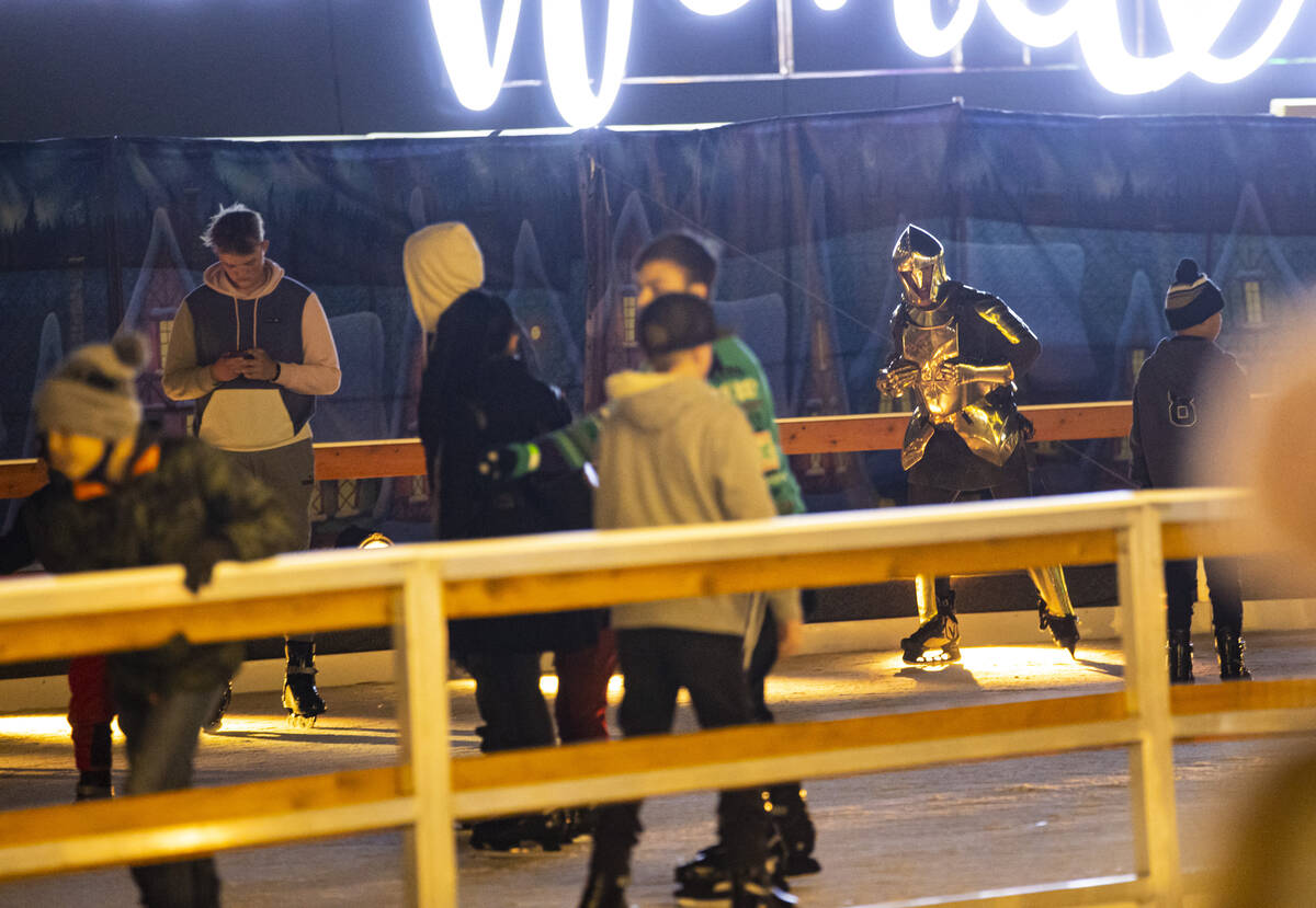 Lee Orchard, the Golden Knight, skates with attendees during the "Knight of Giving" a ...