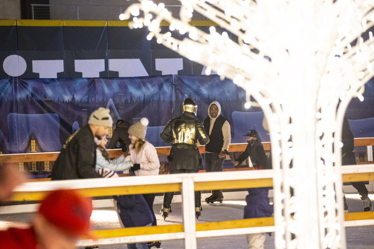 Lee Orchard, the Golden Knight, skates with attendees during the "Knight of Giving" a ...
