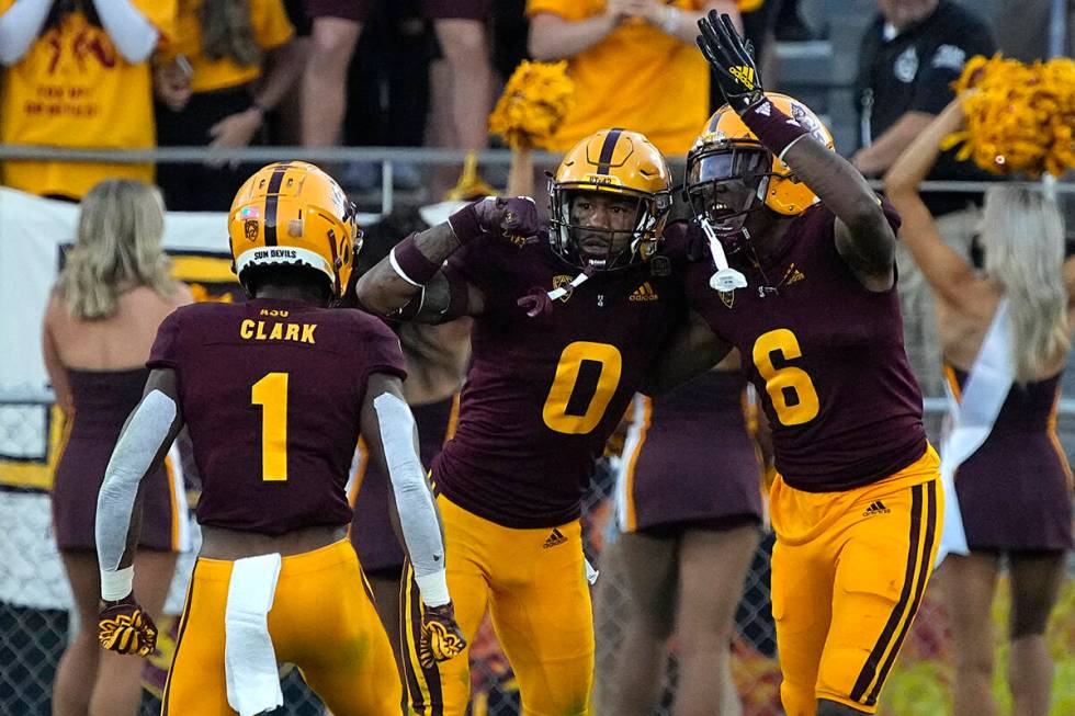 Arizona State defensive back Jack Jones (0) celebrates with defensive back Jordan Clark and def ...