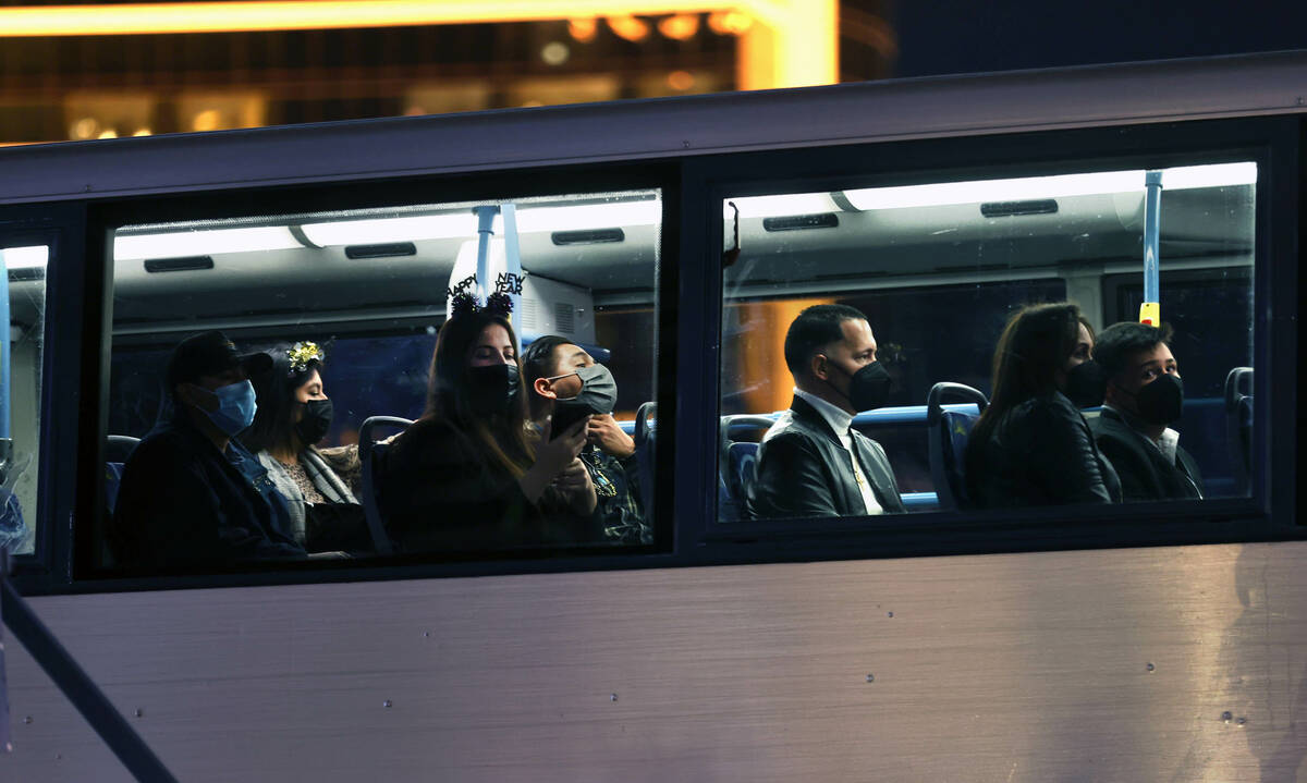 People ride an RTC bus dressed for celebrating along the Strip for New Year’s Eve on Fri ...