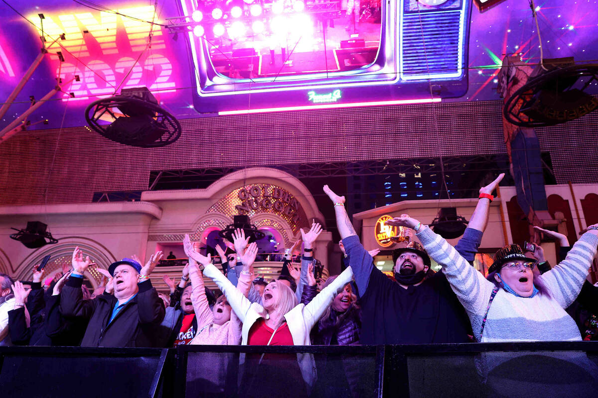 Revelers dance to the Village People on New Year's Eve at the Fremont Street Experience in down ...