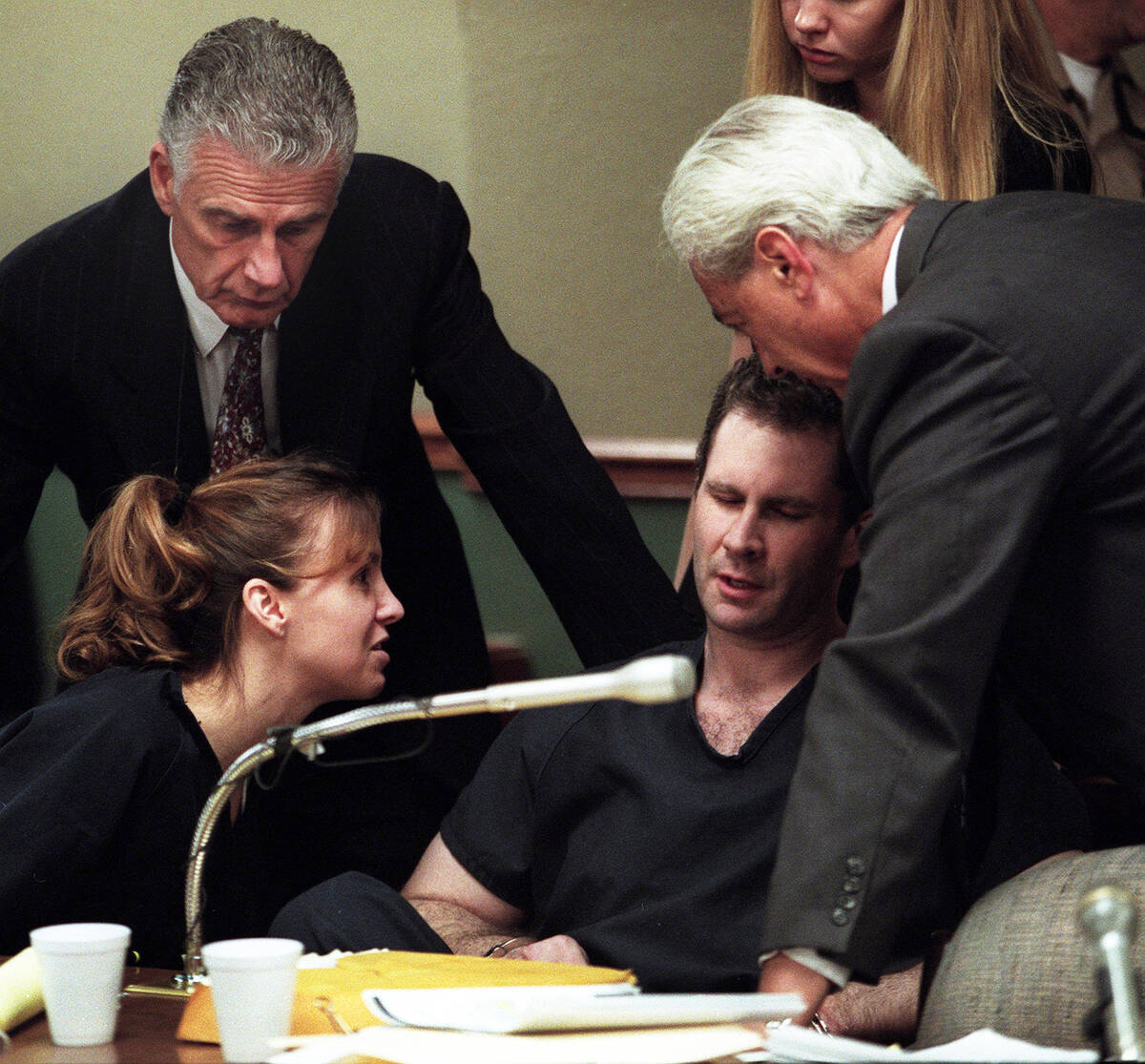Sandy Murphy, left, and attorneys John Momot and Bill Terry console Rick Tabish during a break ...