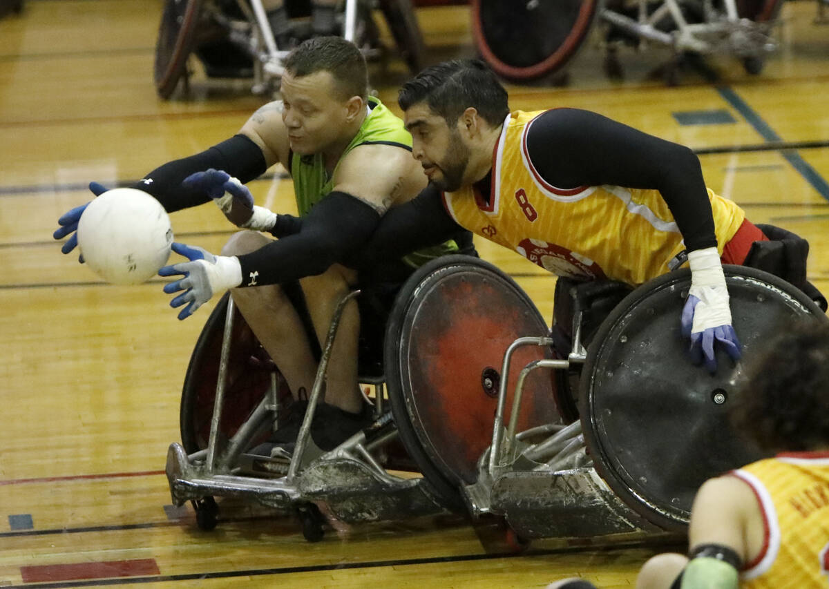 Seattle Slam's Brandon Crider (1) and Las Vegas High Rollers' Jorge Hernandez (8) battle for a ...