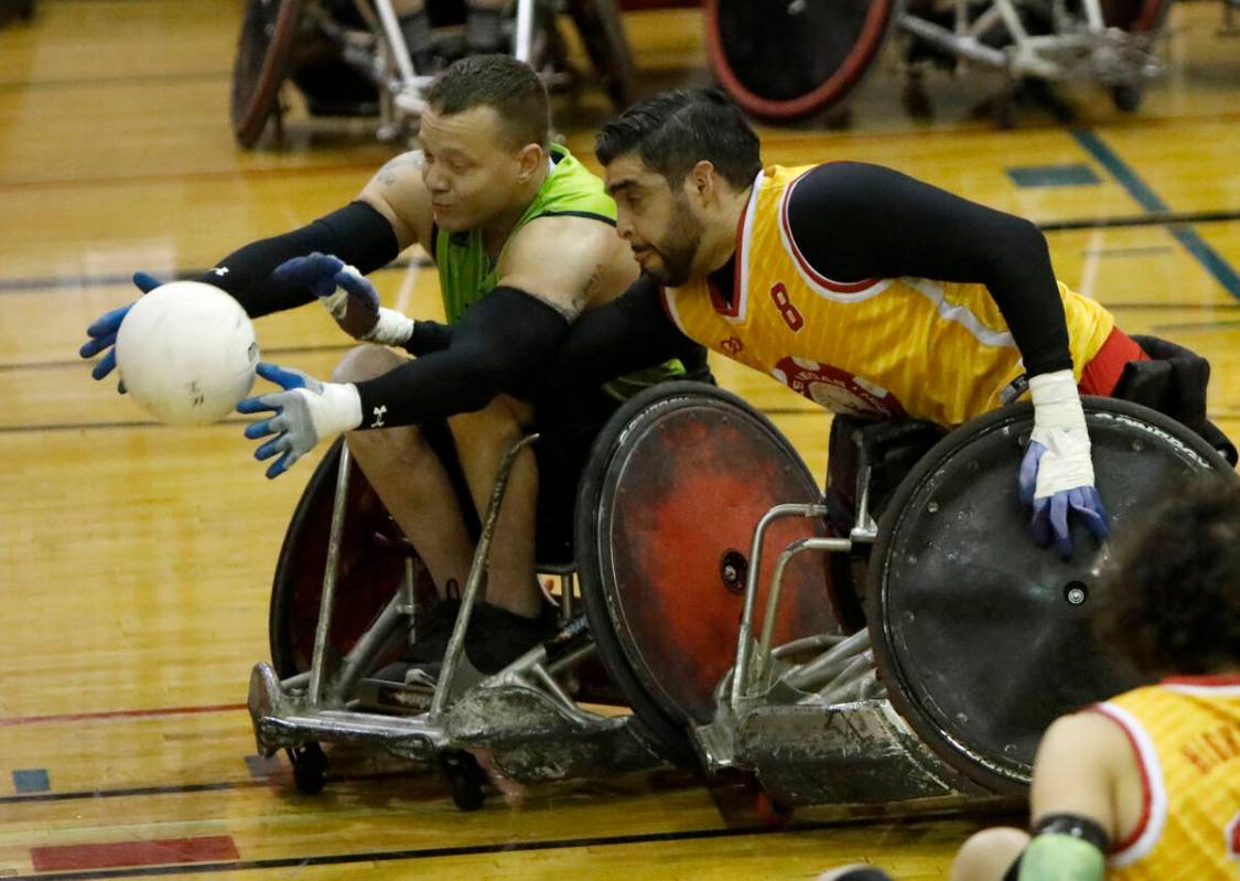 Seattle Slam's Brandon Crider (1) and Las Vegas High Rollers' Jorge Hernandez (8) battle for a ...