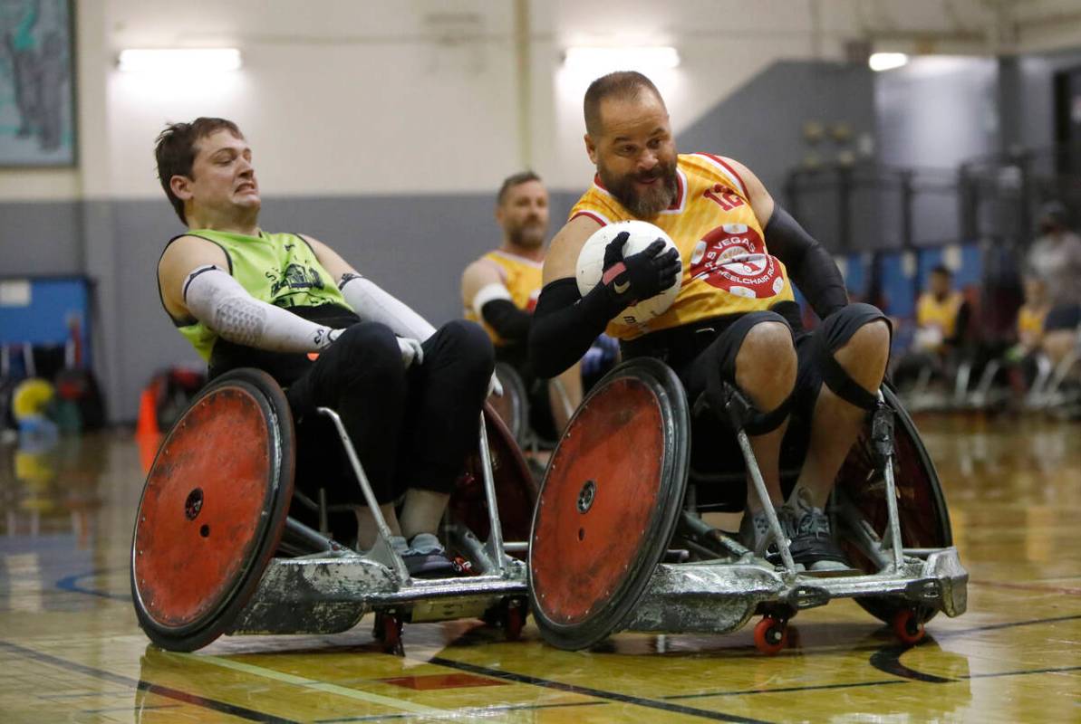 Las Vegas High Rollers' Matt Bambrough (12) right, carries a ball as Seattle Slam's Brian Moor ...