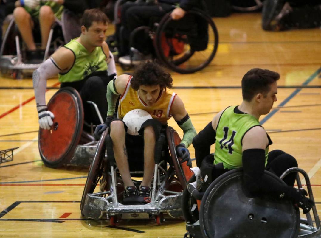Las Vegas High Rollers' CJ Brown (13), center, carries a ball passing through Seattle Slam's Br ...
