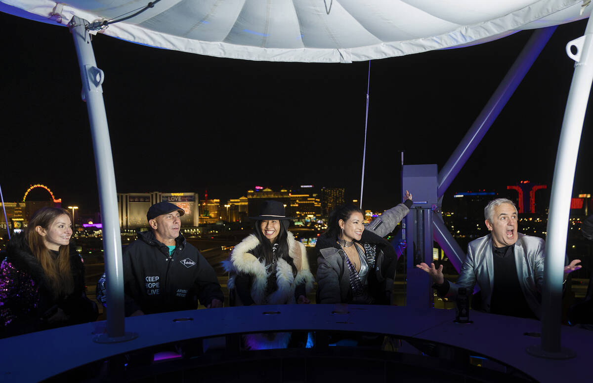 Michael Beneville, right, chief creative officer with AREA15, has fun with guests on the new ri ...