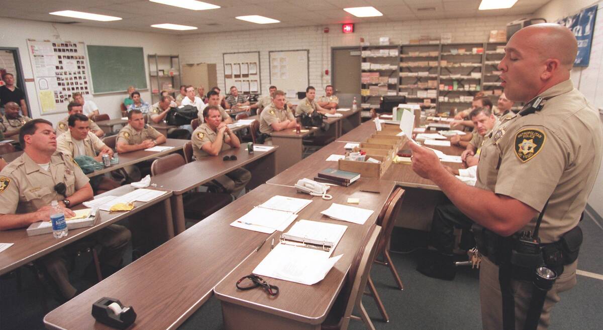 Metro police officer Harry Fagel reads some of his poetry to fellow officers during a briefing ...