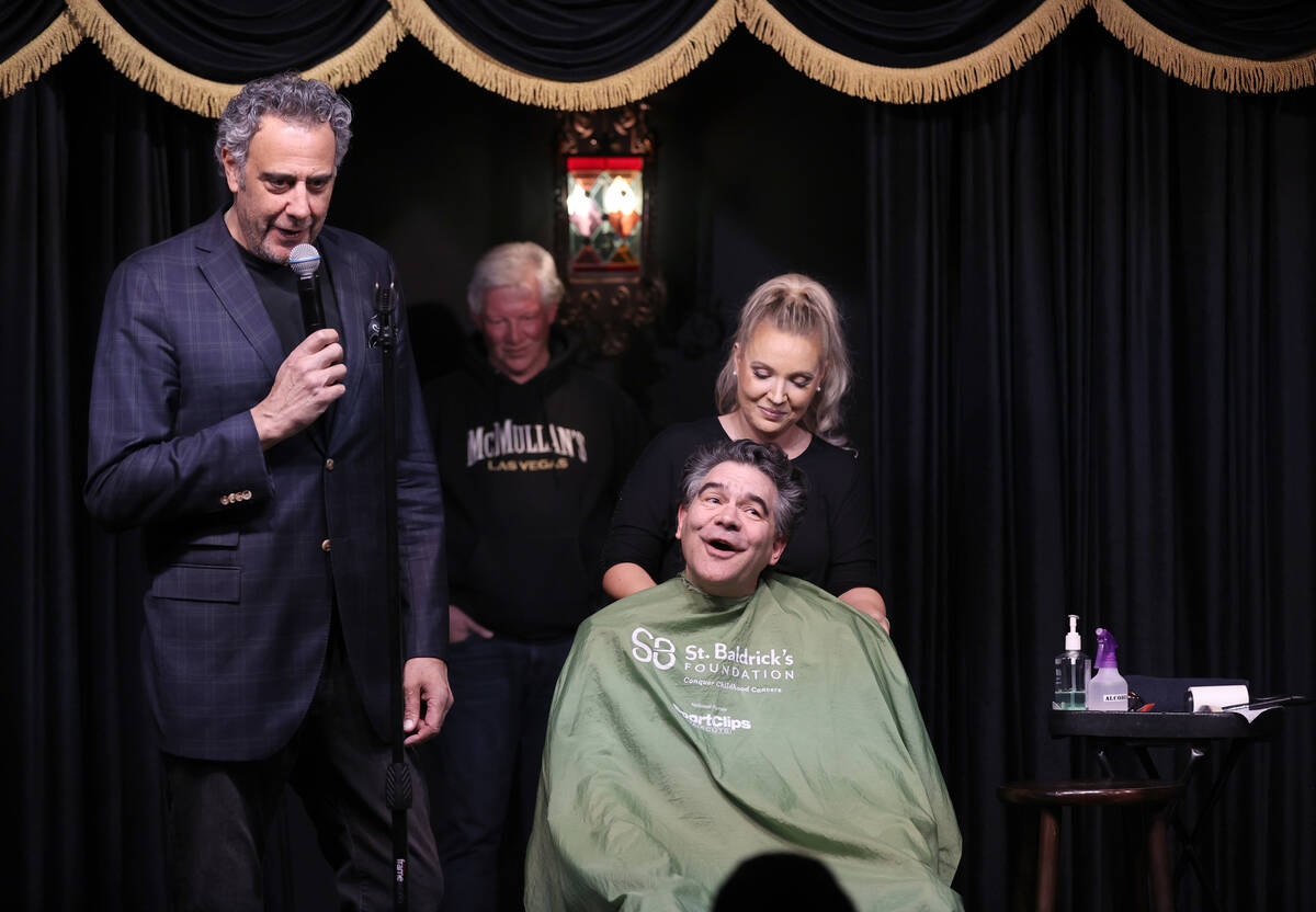 Brad Garrett, left, prepares to shave the head of Las Vegas Review-Journal columnist John Katsi ...