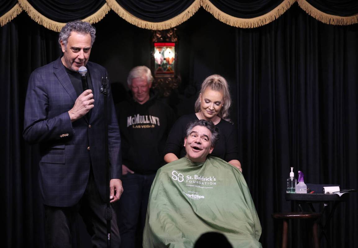 Brad Garrett, left, prepares to shave the head of Las Vegas Review-Journal columnist John Katsi ...