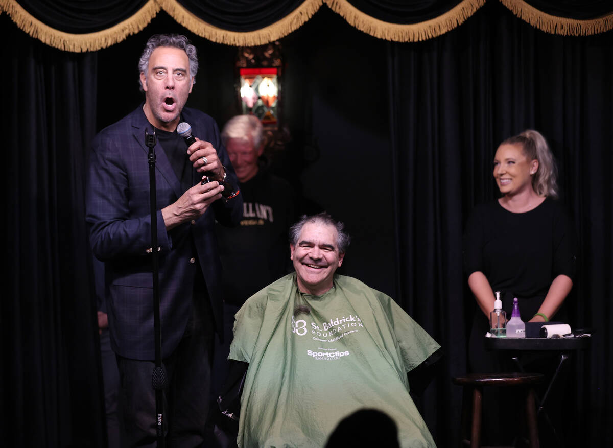 Brad Garrett, left, shaves the head of Las Vegas Review-Journal columnist John Katsilometes dur ...