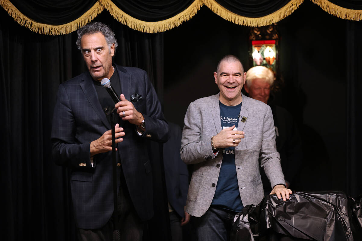 Brad Garrett, left, reacts after shaving the head of Las Vegas Review-Journal columnist John Ka ...