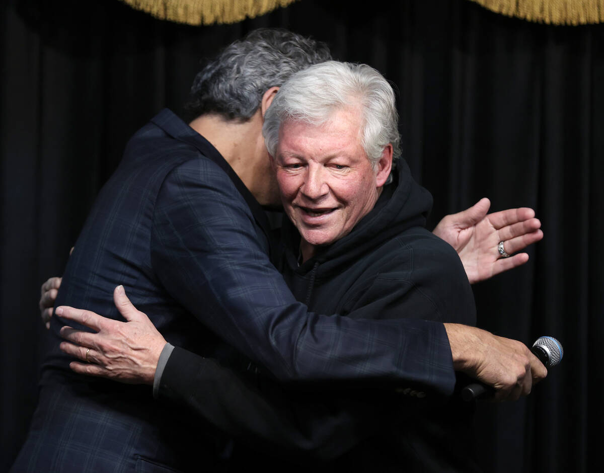 Brian McMullan of McMullan’s Irish Pub, right, hugs Brad Garrett before Garrett shaves t ...