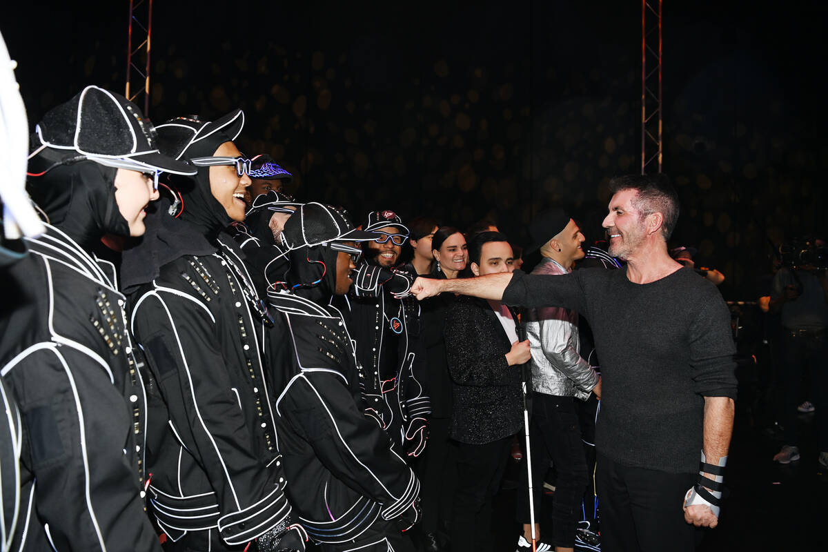 TV entertainment entrepreneur/TV host Simon Cowell is shown with the dance troupe Light Balance ...