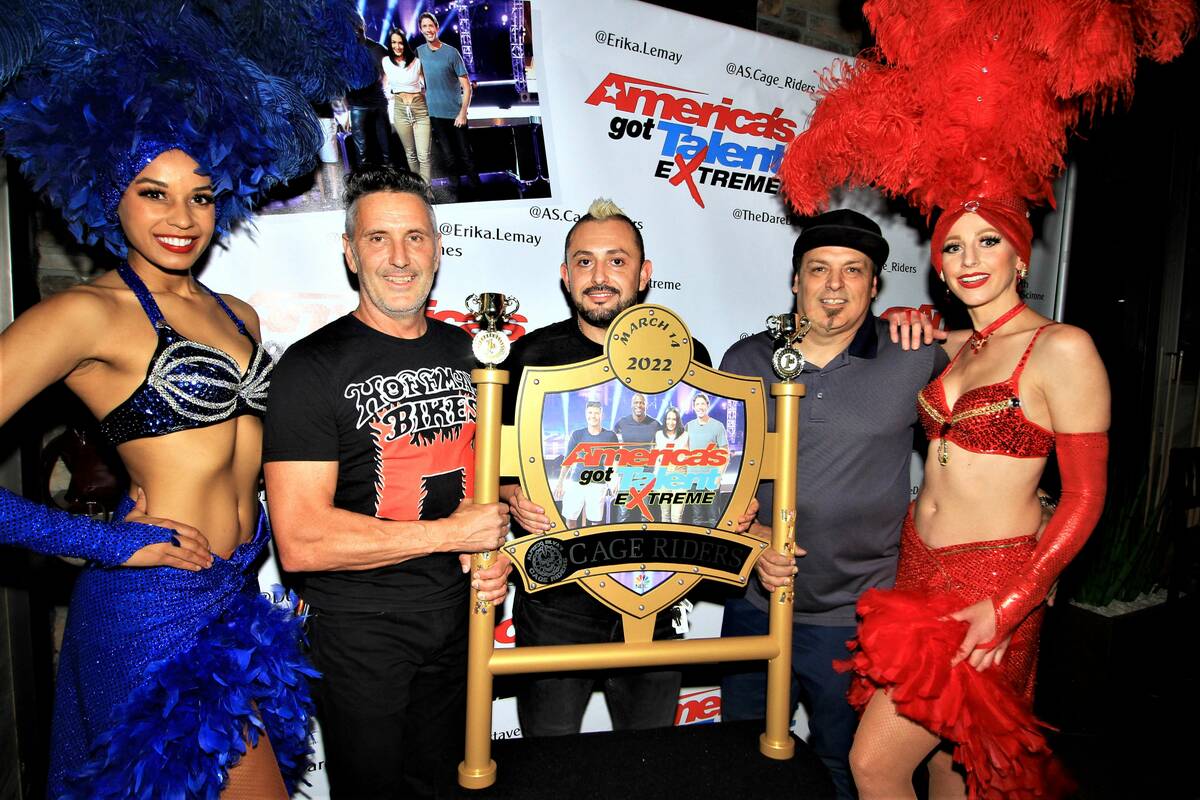 Gary Laurent, Alfredo Silva and John Stotts are flanked by showgirls Ashton Bray (left) and Reb ...