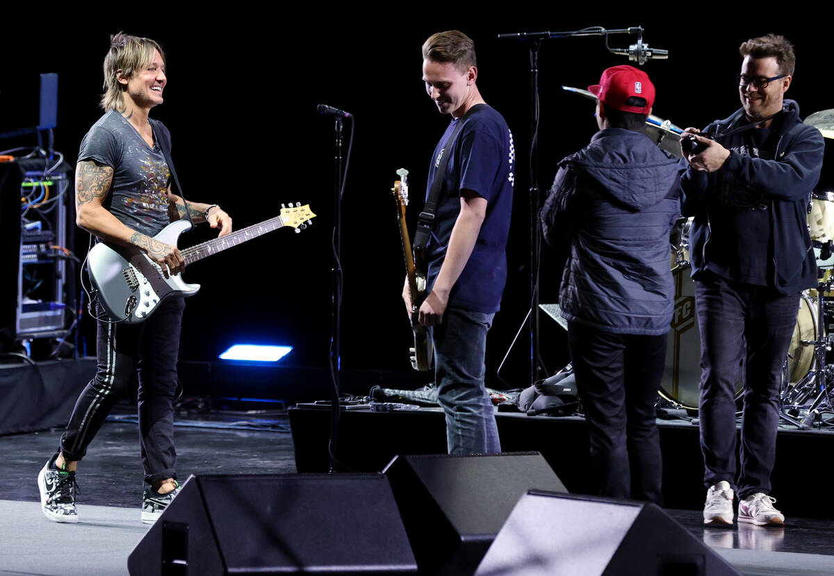 Caesars resident artist Keith Urban jams with Las Vegas Academy student Bradley Love at the Col ...