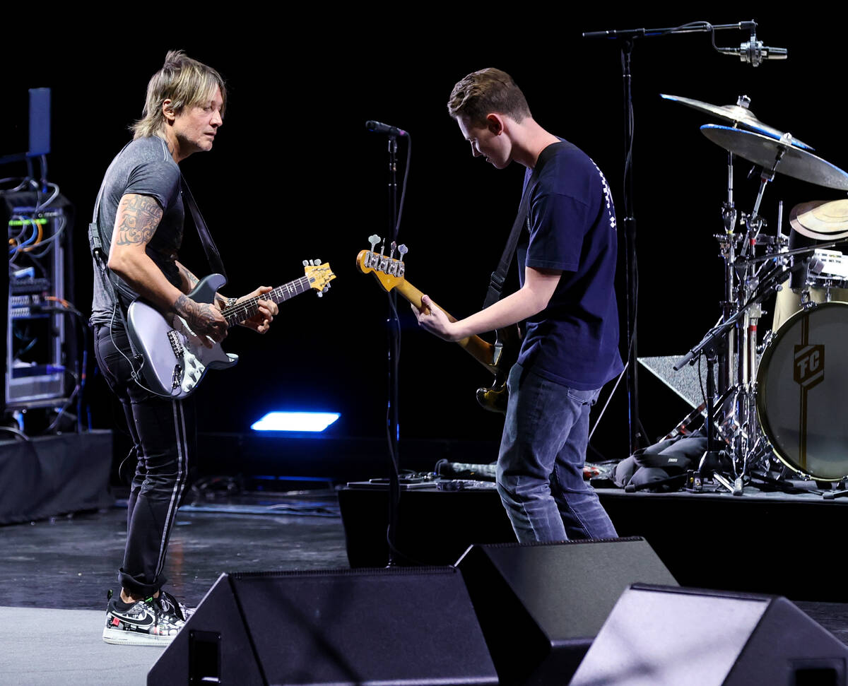 Caesars resident artist Keith Urban jams with Las Vegas Academy student Bradley Love at the Col ...