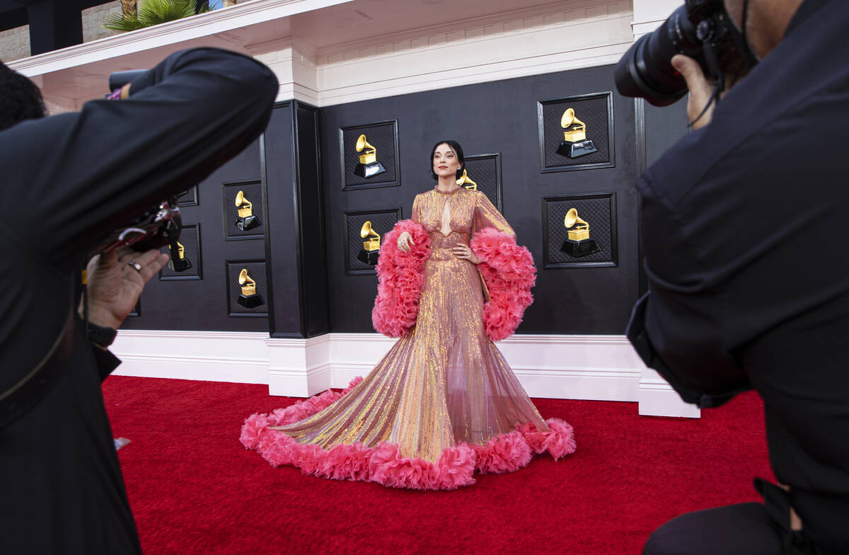 St. Vincent, middle, on the red carpet before the start of the 2022 Grammy Awards on Sunday, Ap ...