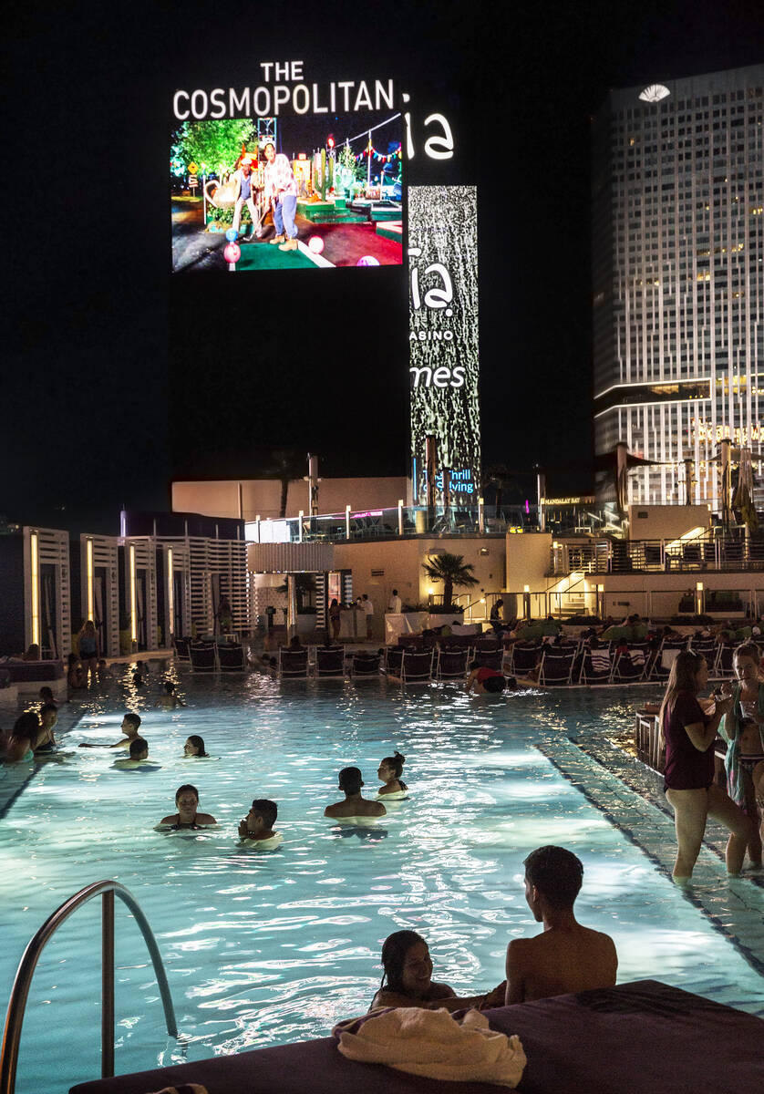Pool goers enjoy a showing of Happy Gilmore during Dive in Movies at Boulevard Pool on Monday, ...