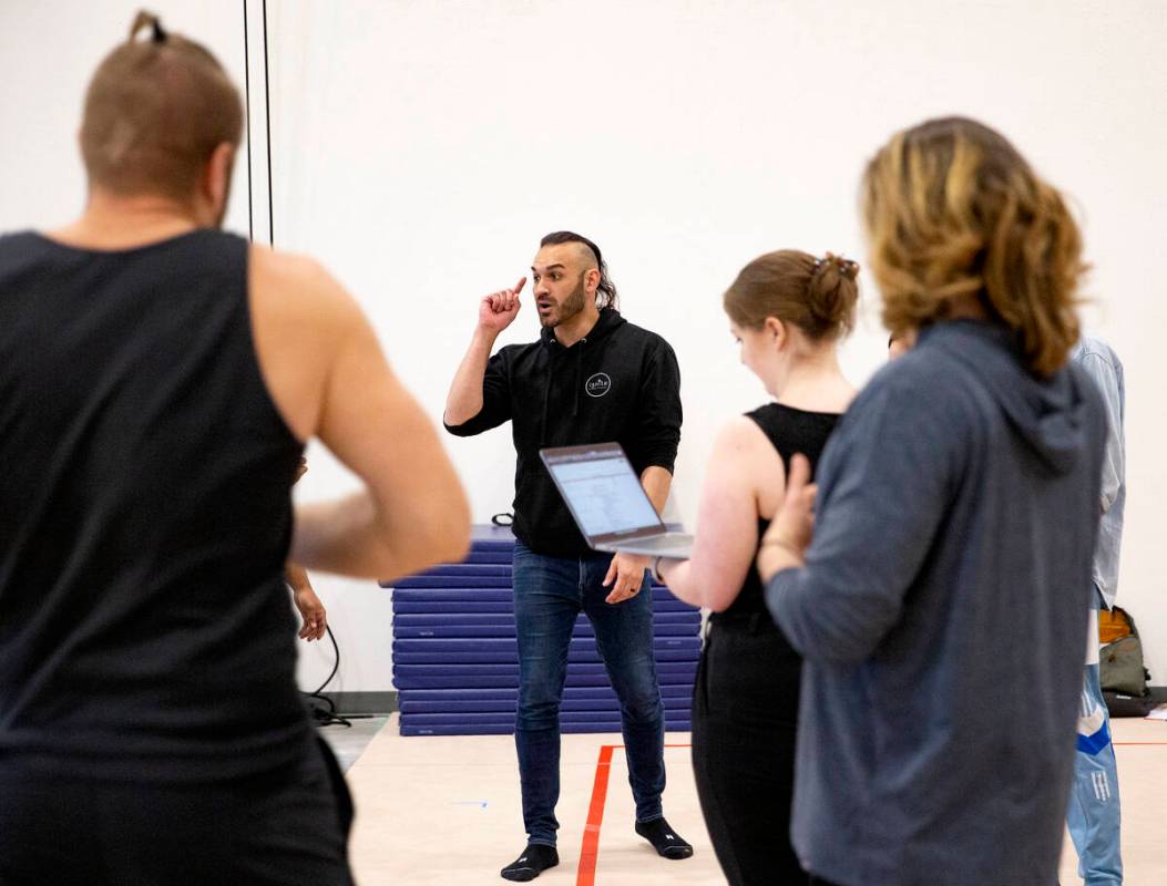 Producer and director of IGNITE Brandon Pereyda, second from left, discusses choreography with ...