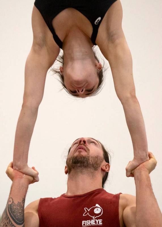 Chris McGreevy and Casey Ely practice a stunt in the teeterboard act during rehearsal for IGNIT ...