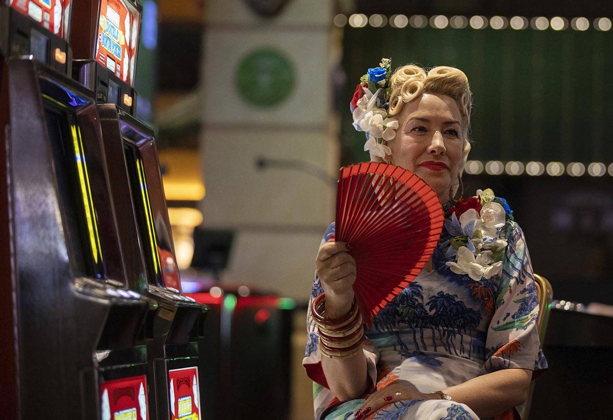 Jenny Tree, from Milford Haven, Whales, UK, cools herself down with a fan during Viva Las Vegas ...