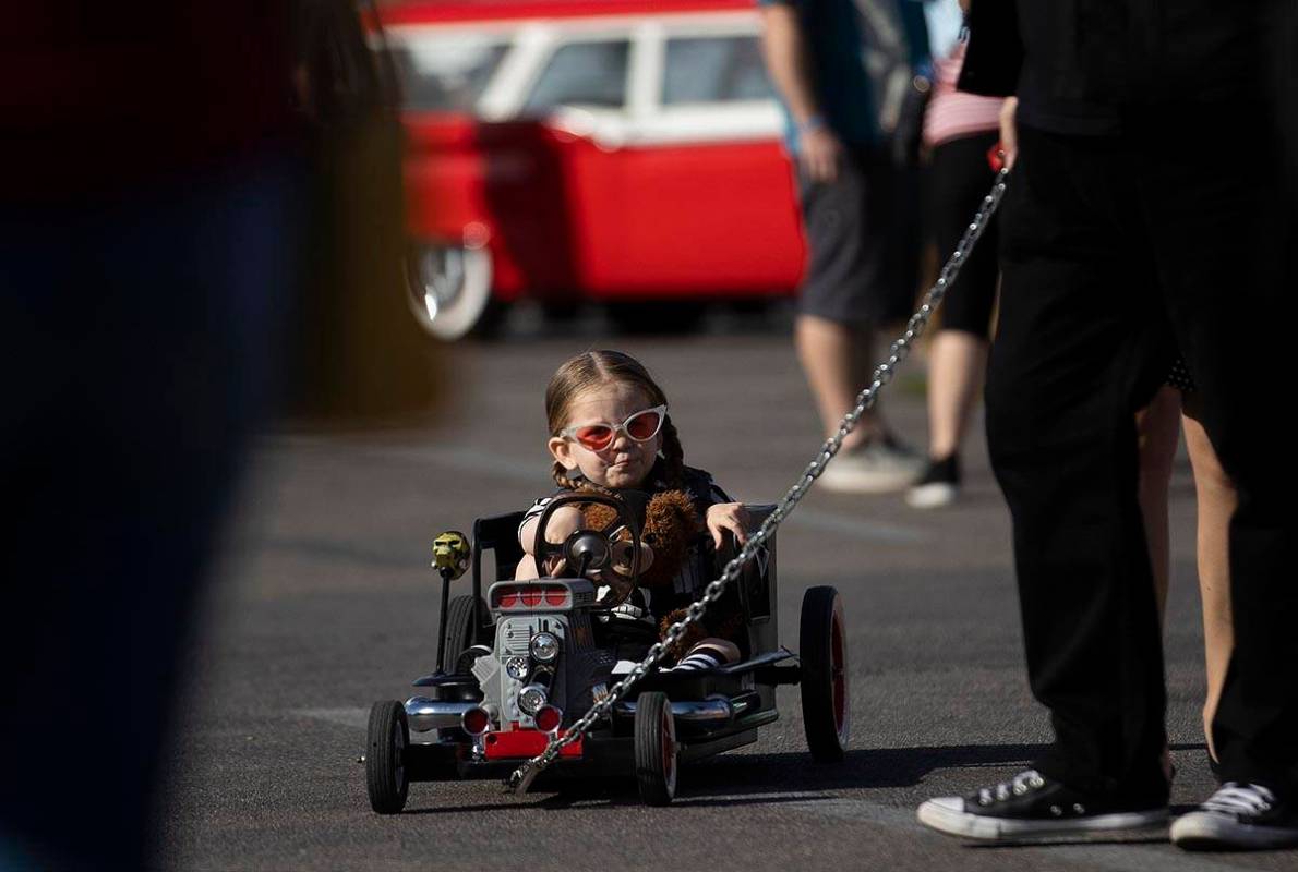 Enrique Vega, from Los Angeles, Calif., is pulled in her miniature hot rod during the Rockabill ...