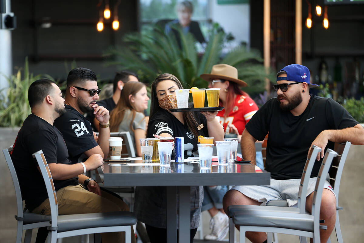 Amanda Otwell, center, delivers drinks to customers at The Front Yard inside of the Ellis Islan ...