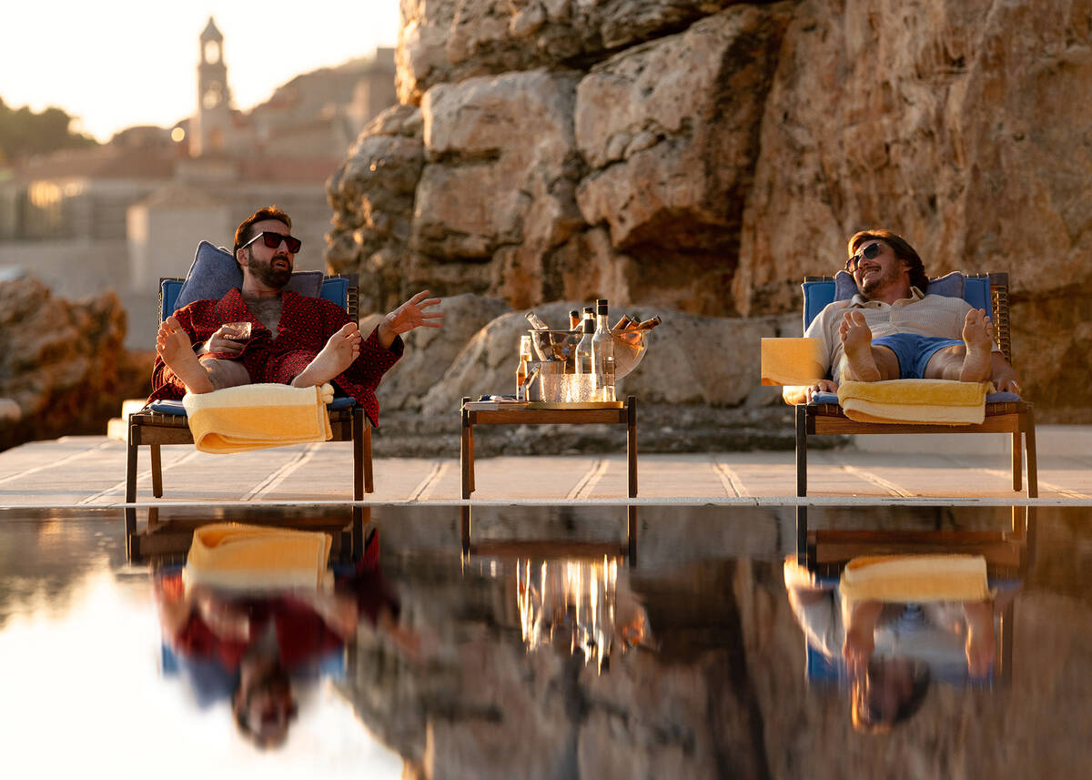 ‘Nicolas Cage' (Nicolas Cage, left) enjoying a welcome drink on 'Javi Gutierezz's' (Pedr ...