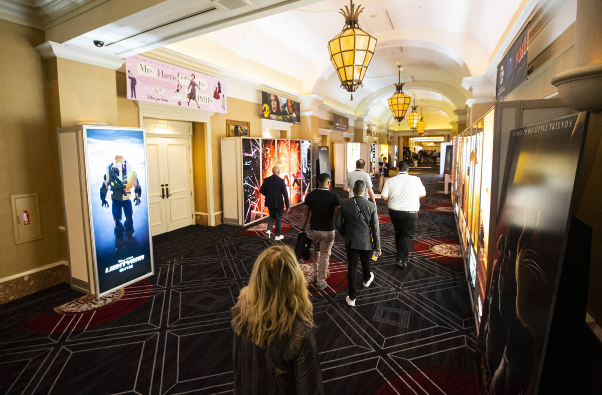 Attendees walk by movie displays at the CinemaCon trade show at Caesars Palace on Tuesday, Apri ...