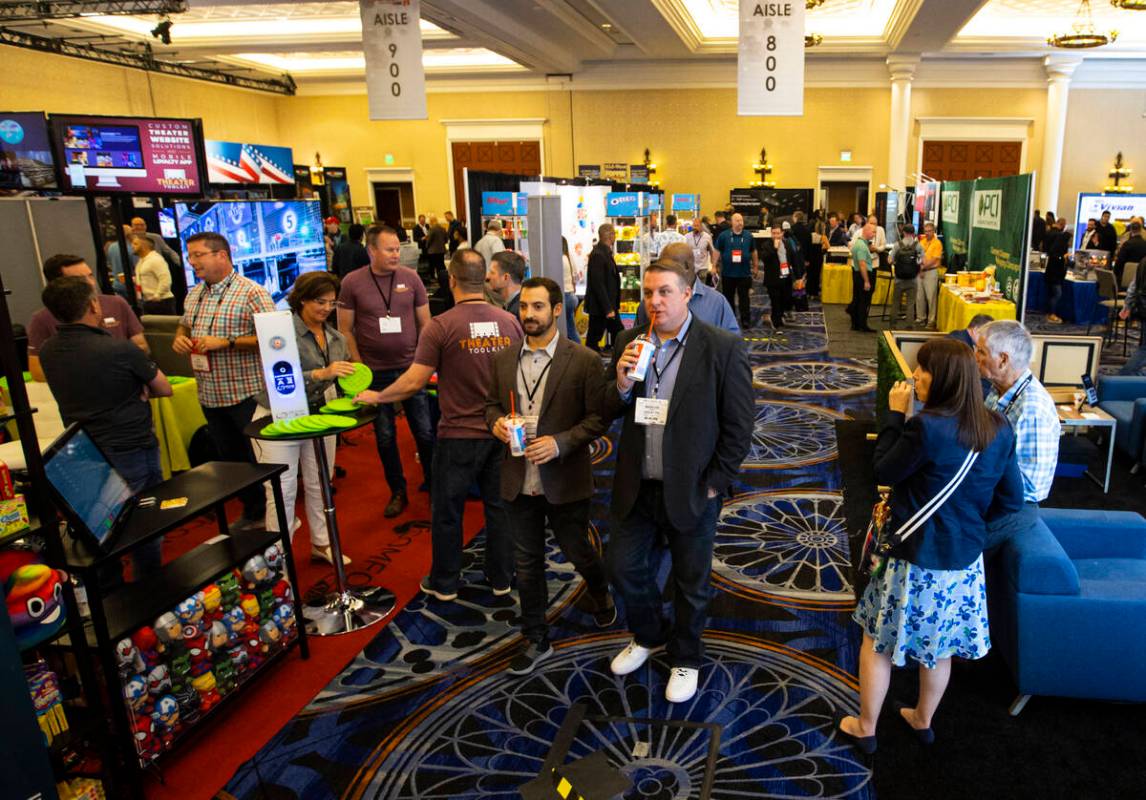 People walk the show floor at the CinemaCon trade show at Caesars Palace on Tuesday, April 26, ...