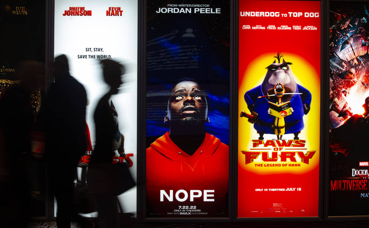 Attendees pass by movie posters at the CinemaCon trade show at Caesars Palace on Tuesday, April ...