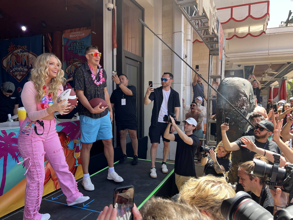 Rob Gronkowski and his girlfriend Camille Kostek toss out signed footballs during Gronk Beach p ...