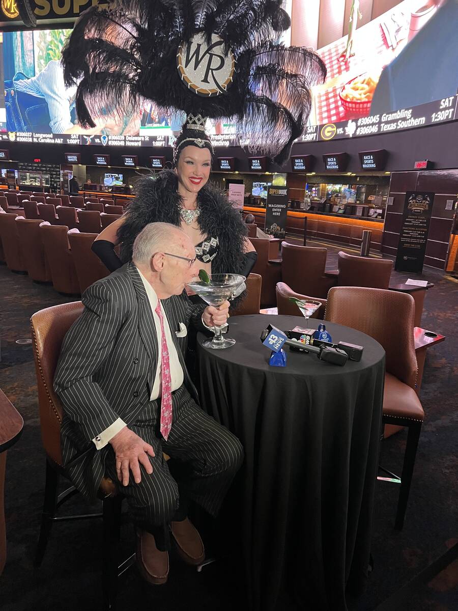 Oscar Goodman enjoys a pre-Super Bowl bet martini, with Showgirl Kristina looking on, at Westga ...