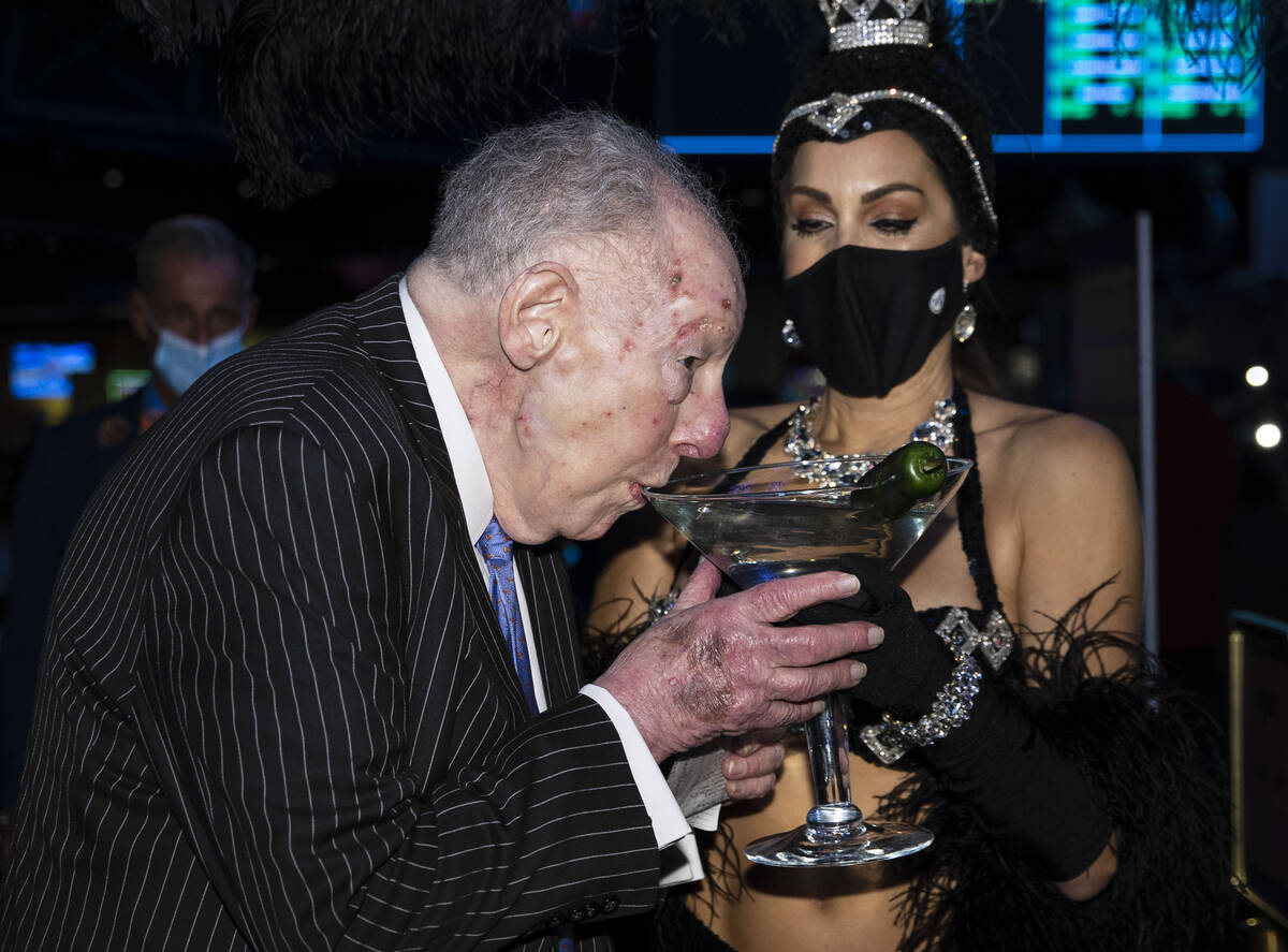 Former Las Vegas Mayor Oscar Goodman sips his martini before placing his March Madness wager ...