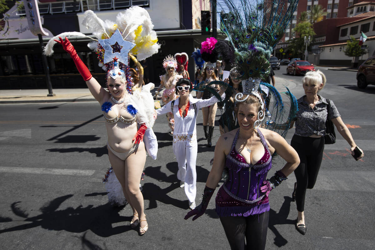 Participants in the Las Vegas Showgirl parade walk cross Fremont Street on Sunday, May 15, 2022 ...