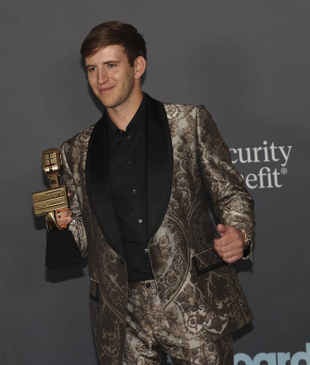DJ Illenium poses with the “Top Dance/Electronic Album” award in the backstage press room d ...