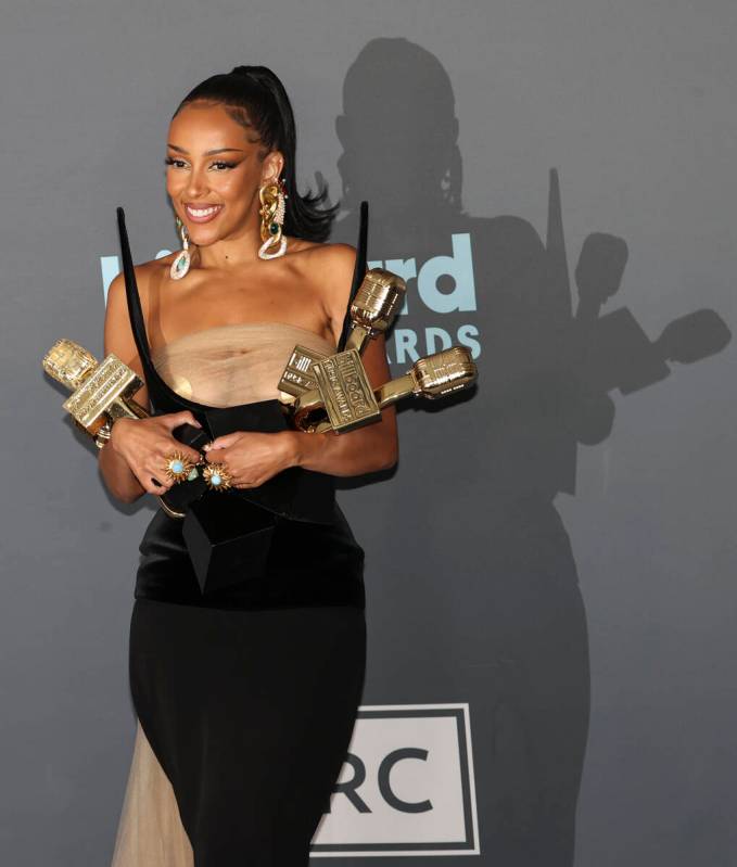 Doja Cat poses with her awards in the backstage press room during the Billboard Music Awards at ...