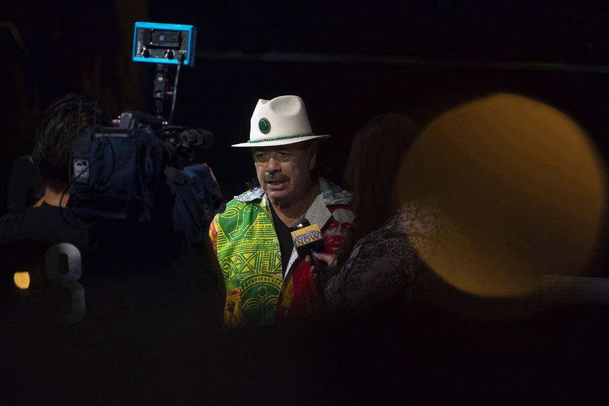 Carlos Santana talks to reporters during a press conference to announce an extension of Santana ...