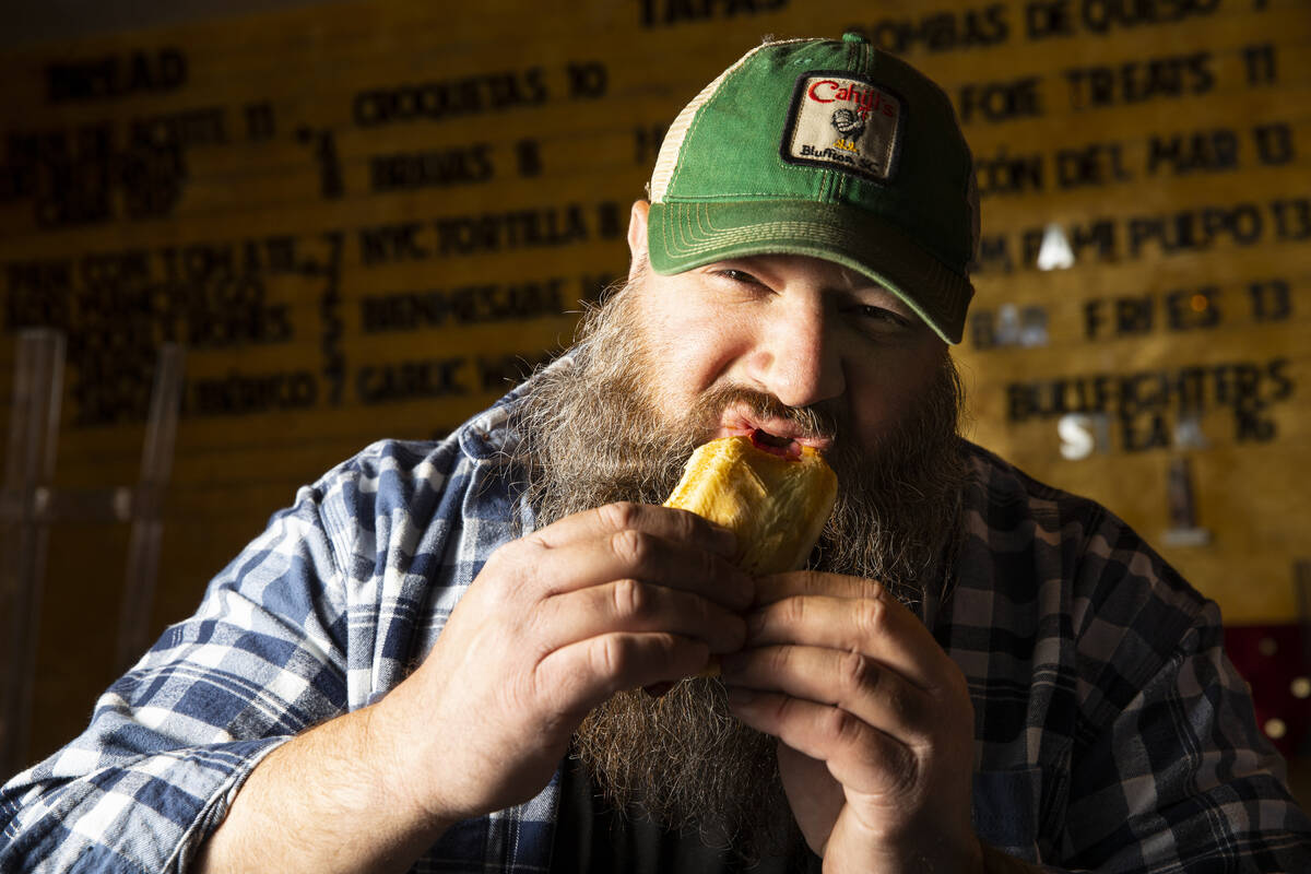 Ralph Perrazzo, founder of Snap-O-Razzo, eats a Snap-O-Razzo hot dog on Tuesday, April 5, 2022, ...