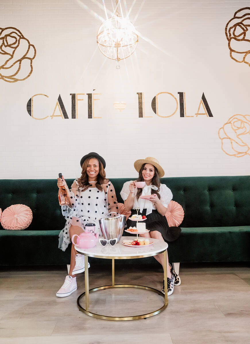 Lin Jerome, left, and Alexandra Lourdes take a moment amid the signature pink and sparkle of Ca ...